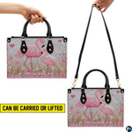 Matching pink flamingo wallet displayed flat showing exterior mother and chick artwork.