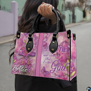 Arrangement of pink handbag and wallet presenting the unified floral cross theme.