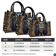 Bottom view of baroque owl handbag showing protective metal feet studs and smooth base wrap