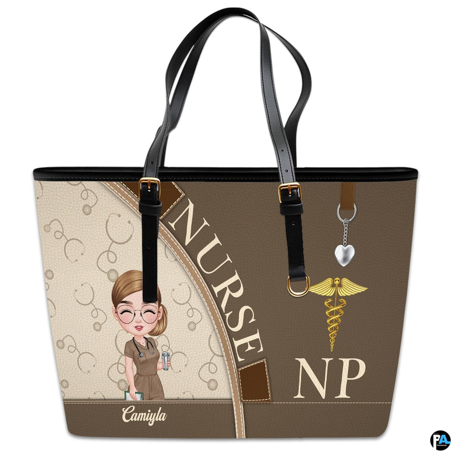 Studio display of Mocha Clinician Tote Handbag showing chibi clinician, golden caduceus, and heart charm graphic.