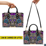 Jeweled skull handbag carrying demonstration showing top handle and shoulder strap carry.