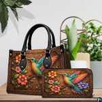 Handbag and matching wallet set displayed together on wooden table beside a green houseplant.