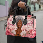 Daylight street presentation highlighting the floral faith portrait design held in natural light.