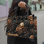 Golden skull handbag carried outdoors by top handle along residential street.