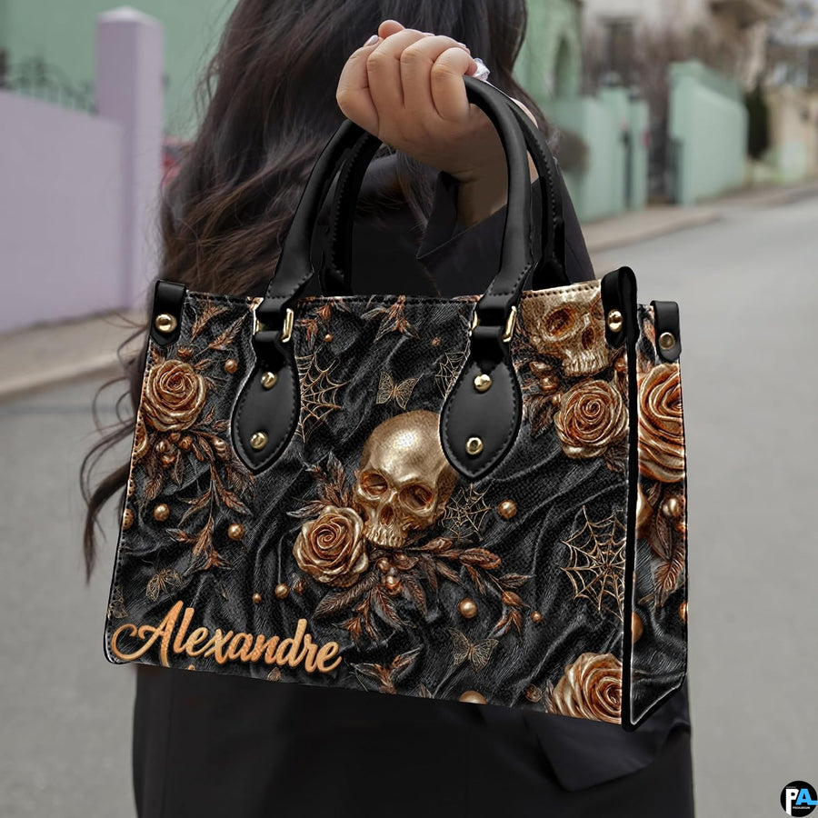 Golden skull handbag carried outdoors by top handle along residential street.