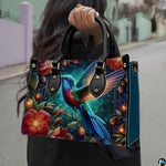 Angled display of jewel-toned botanical purse paired with coordinating zippered companion wallet.