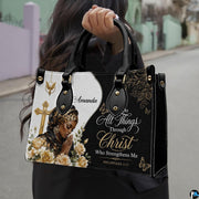 Model outdoors carrying the faith praying woman handbag with top handles and cross design