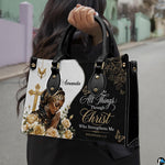 Model outdoors carrying the faith praying woman handbag with top handles and cross design