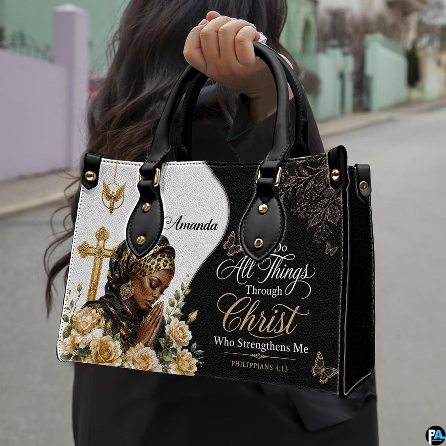 Model outdoors carrying the faith praying woman handbag with top handles and cross design