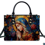 Front view of handbag featuring Virgin Mary in prayer surrounded by vibrant stained glass roses