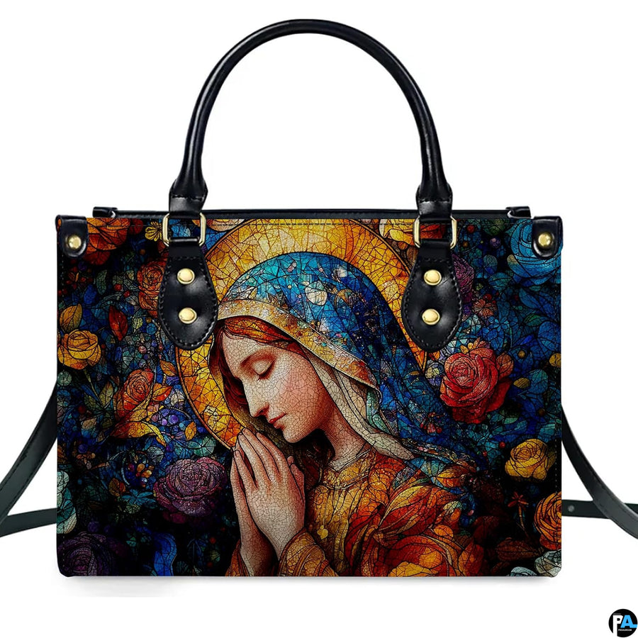 Front view of handbag featuring Virgin Mary in prayer surrounded by vibrant stained glass roses