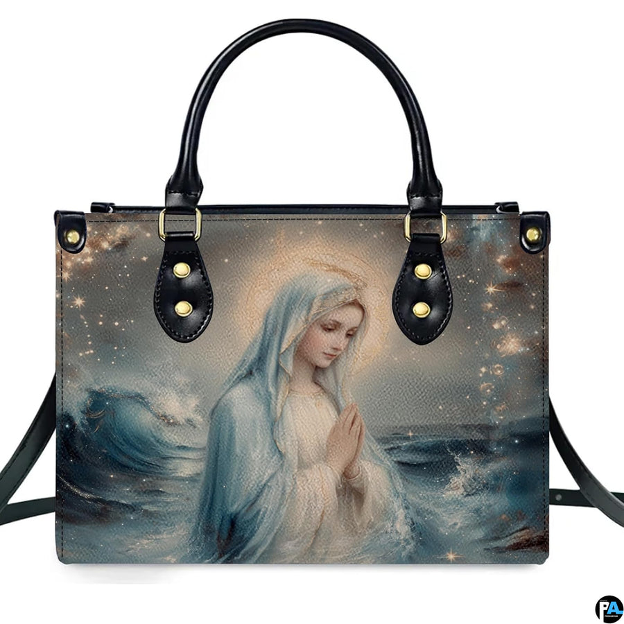 Front isolated view of Stella Maris handbag featuring Virgin Mary and starry waves.