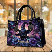 Angled tabletop view showing floral witch cat artwork resting near a sunlit cafe window.