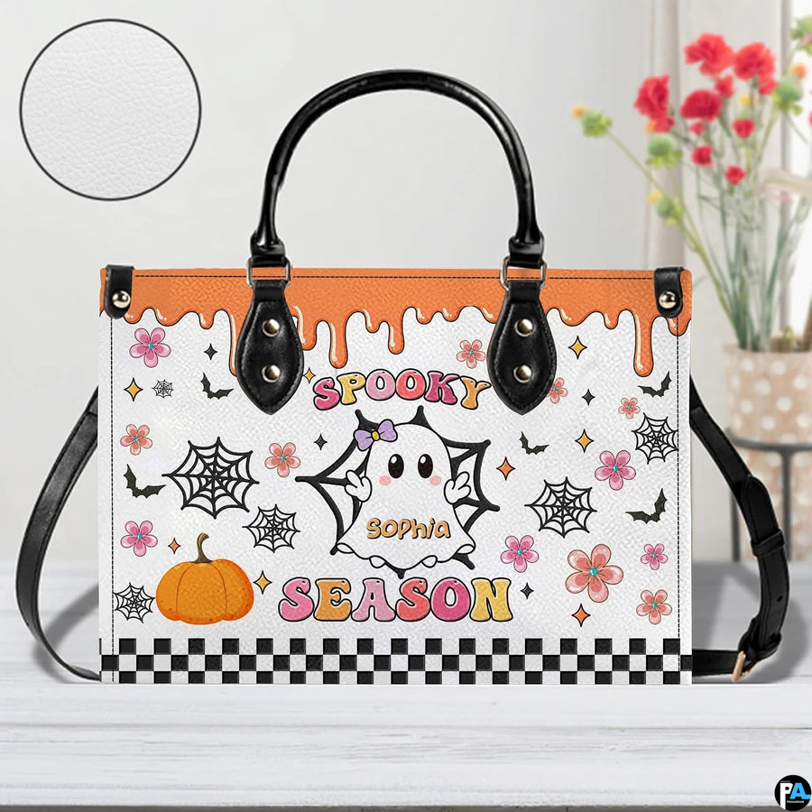 Tabletop presentation of cartoon ghost artwork positioned beside floral vase and circular texture inset.