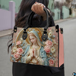 Lifestyle display of porcelain relief Madonna handbag carried by model showing artwork and scale