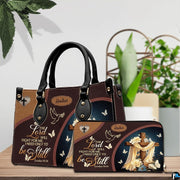 Christian wooden cross handbag and matching wallet set on wooden table near houseplant.