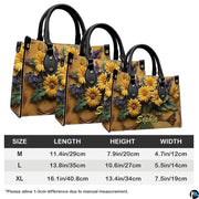 Side perspective view of yellow daisy bouquet handbag and wallet pair