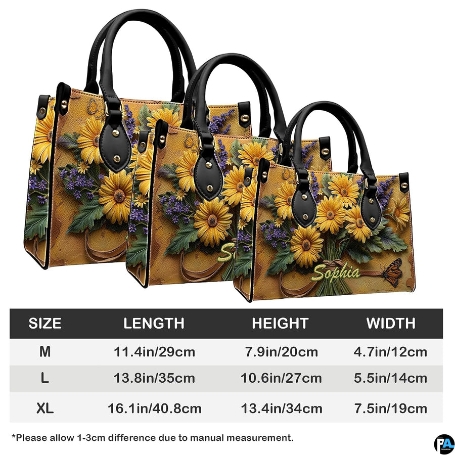 Side perspective view of yellow daisy bouquet handbag and wallet pair