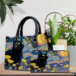 Black cat van gogh starry night design resting beside potted greenery on a tabletop.