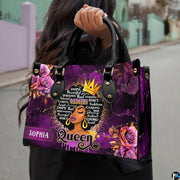 Close-up front view of crowned queen portrait with purple roses on structured tote handbag