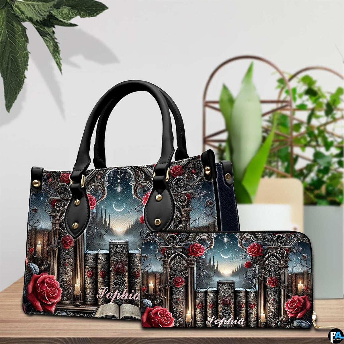Gothic cathedral handbag and wallet set shown together on wooden tabletop next to green plant.