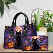 Tabletop view of winged black cat and pumpkin artwork placed beside indoor house plants on wooden table.