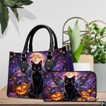 Tabletop view of winged black cat and pumpkin artwork placed beside indoor house plants on wooden table.