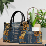 Tabletop display showing Christian cross butterfly handbag and matching wallet beside indoor plants