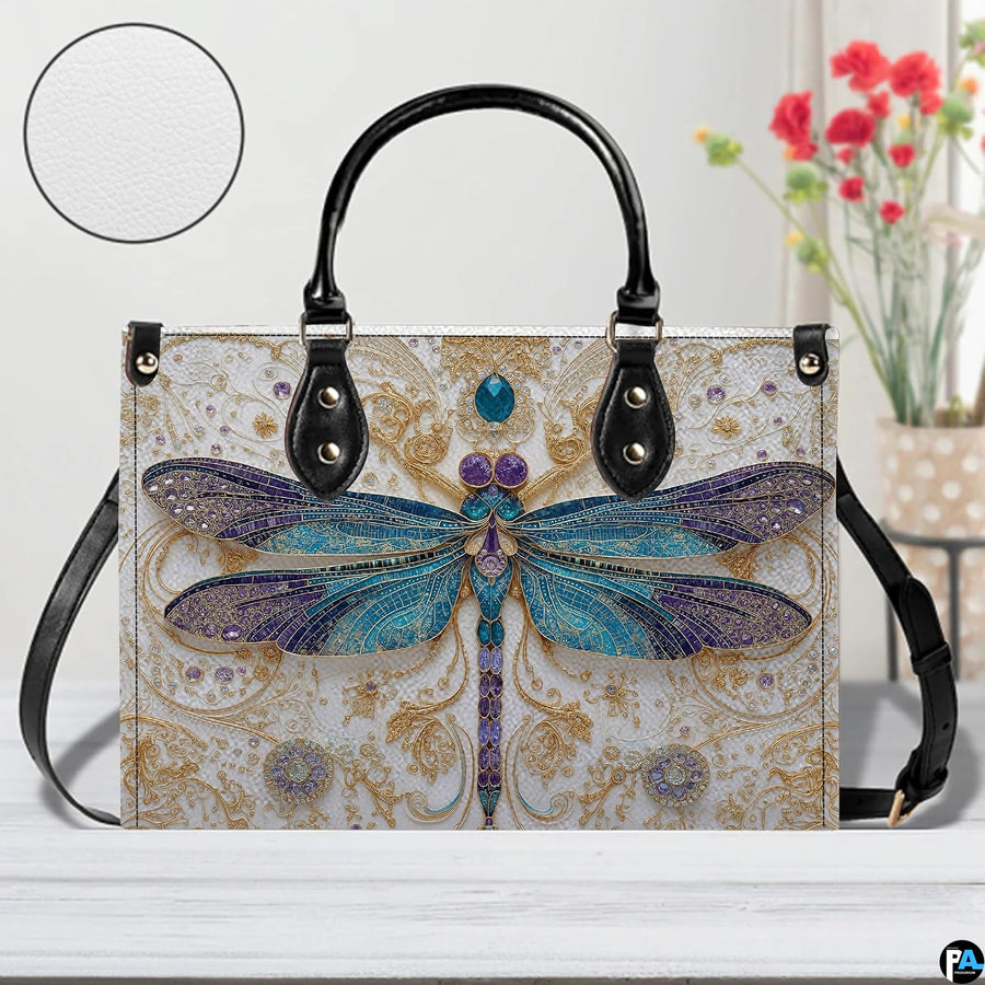 Side profile view showing structured silhouette and black carrying handles of the handbag.