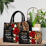 Christian leopard handbag and wallet displayed on wooden table beside potted plant.