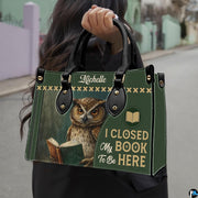 Model carrying the reading owl handbag outdoors displaying the front book cover artwork.