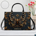Tabletop perspective of antique gold butterfly handbag standing upright on wooden surface