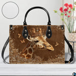 Angle perspective view of the giraffe handbag showcasing side depth and textured bronze print.
