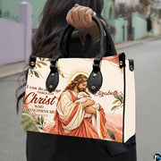 Good Shepherd handbag carried outdoors by top handle on residential street.
