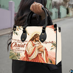 Good Shepherd handbag carried outdoors by top handle on residential street.