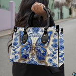 Model carrying blue porcelain butterfly handbag outdoors