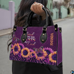 Angled display showing purple sunflower handbag beside matching personal organizer