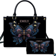 Front view of ornate floral butterfly handbag with matching zip wallet on solid black backdrop