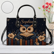 Angled view displaying the starry celestial reading owl artwork on the structured handbag.
