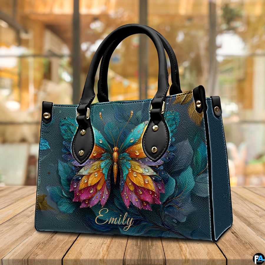 Back view of butterfly handbag displaying smooth dark teal textured exterior surface