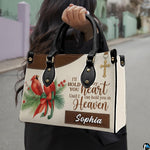 Outdoor lifestyle presentation showcasing the cardinal memorial handbag carried by an individual.