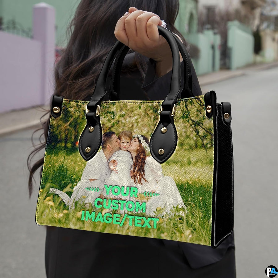 Sunny meadow family portrait handbag held outdoors showing scale against street background.