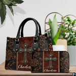 Detailed view of western turquoise cross handbag highlighting dark accents and ornate scrollwork.