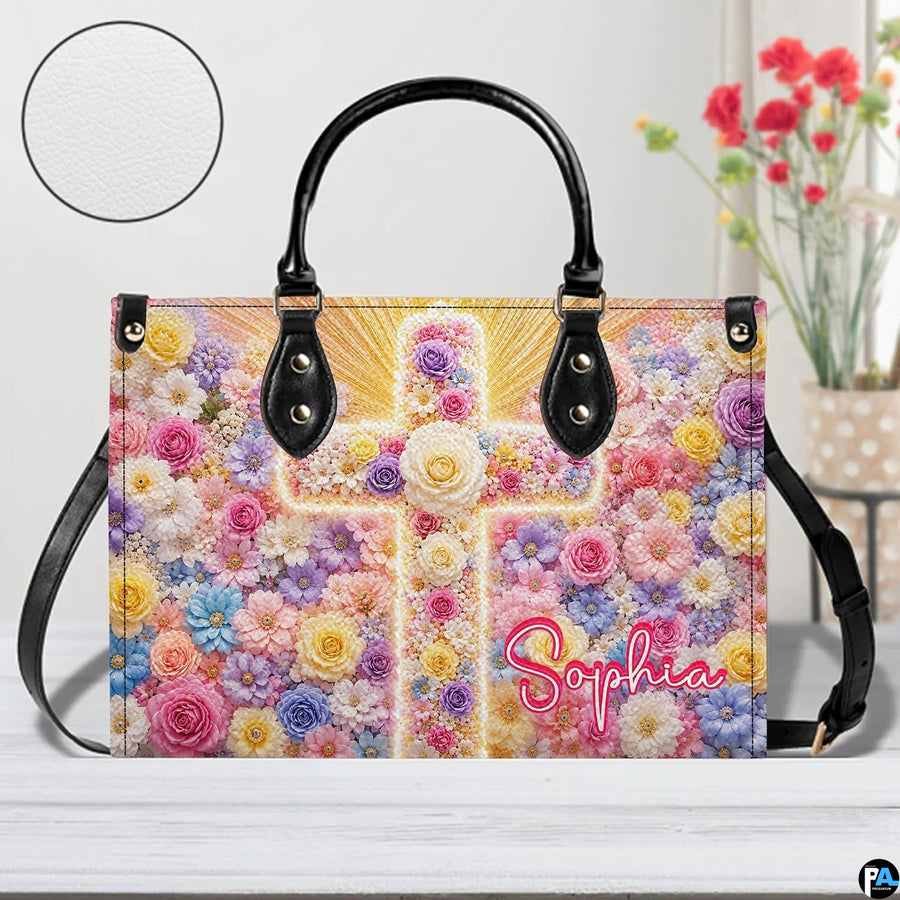 Front view of floral cross handbag on white tabletop with circular textured exterior swatch.