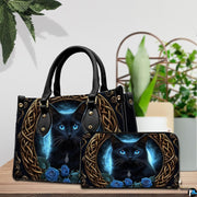 Indoor presentation of Celtic black cat artwork alongside matching companion accessory on wooden tabletop near plants.
