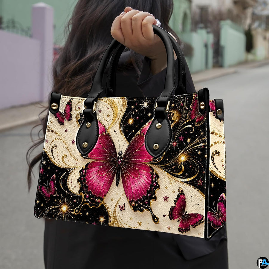 Outdoor street perspective showing magenta butterfly artwork held by pedestrian along town sidewalk.