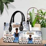 Afro puff art accessory and companion piece positioned on wooden table beside lush indoor greenery.