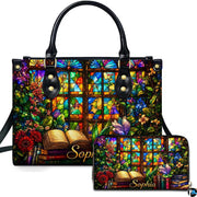 Front view of accessory set featuring stained glass window, climbing floral vines, and open book resting on book stack