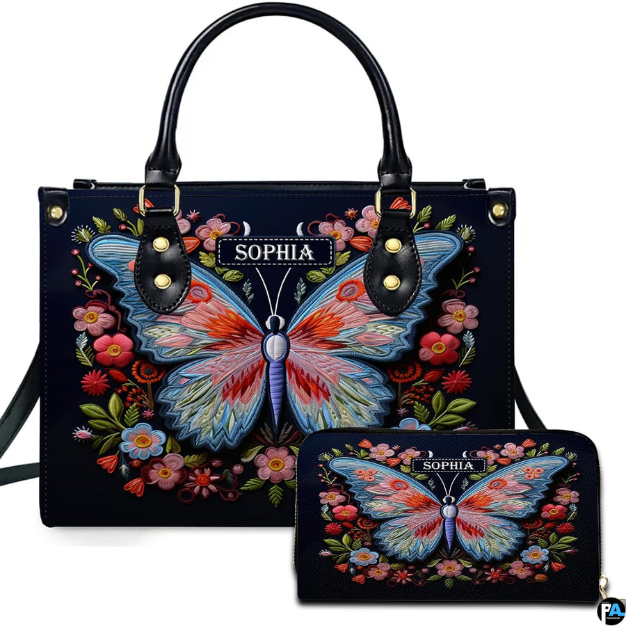 Handbag and matching wallet set featuring an embroidered butterfly and floral wreath on midnight navy.