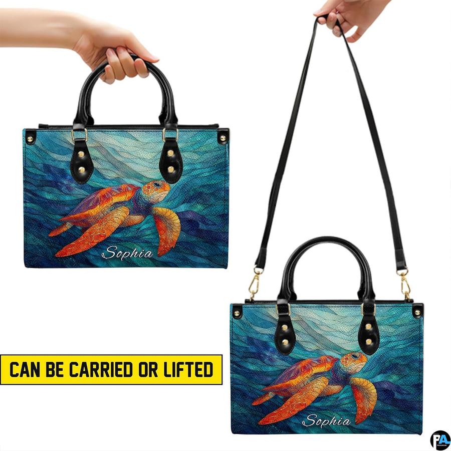 Matching wallet displaying the mosaic orange sea turtle swimming through rhythmic waves.